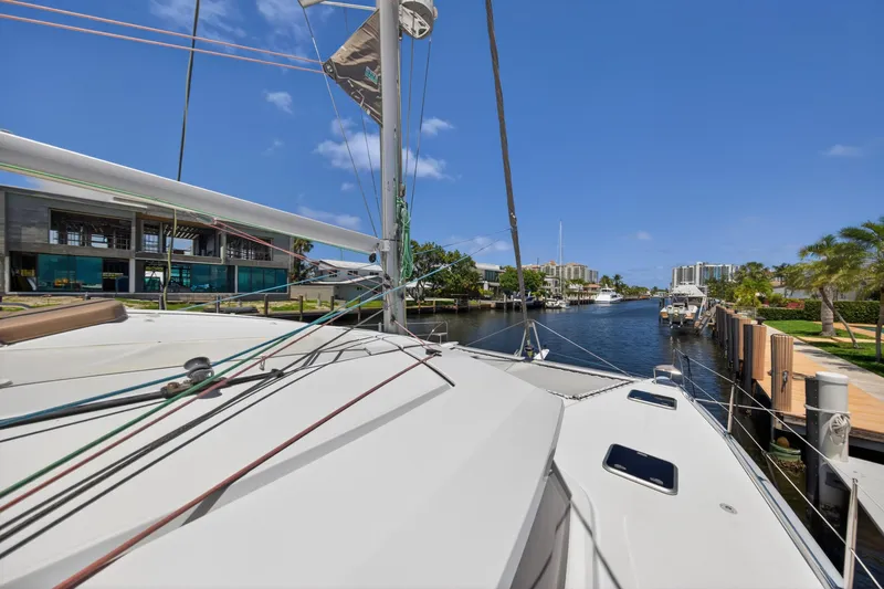 Slide: The Image of 2015 Fountaine Pajot Helia 44 catamaran docked in a scenic marina. - 47