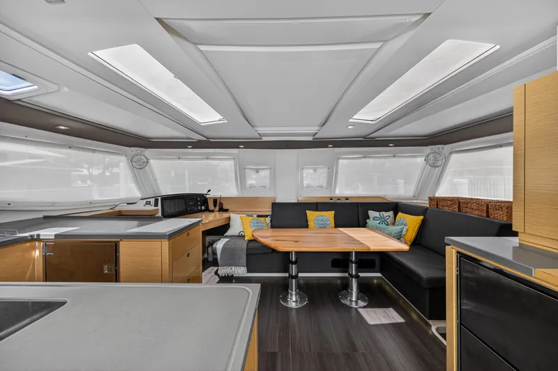 Slide: The Image of Interior of 2015 Fountaine Pajot Helia 44 catamaran with modern kitchen and cozy seating area. - 48