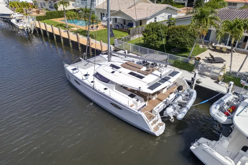 Slide: The Image of Aerial view of 2015 Fountaine Pajot Helia 44 catamaran docked by waterfront homes. - 5