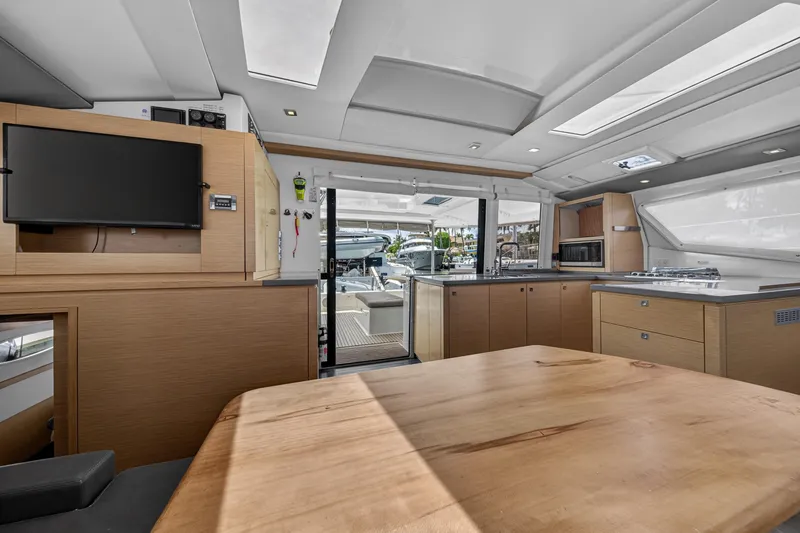Slide: The Image of Interior of 2015 Fountaine Pajot Helia 44 catamaran with modern kitchen and dining area. - 55