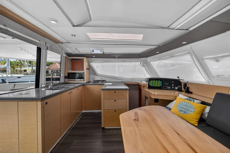 Slide: The Image of Interior of 2015 Fountaine Pajot Helia 44 catamaran with modern kitchen and navigation area. - 56