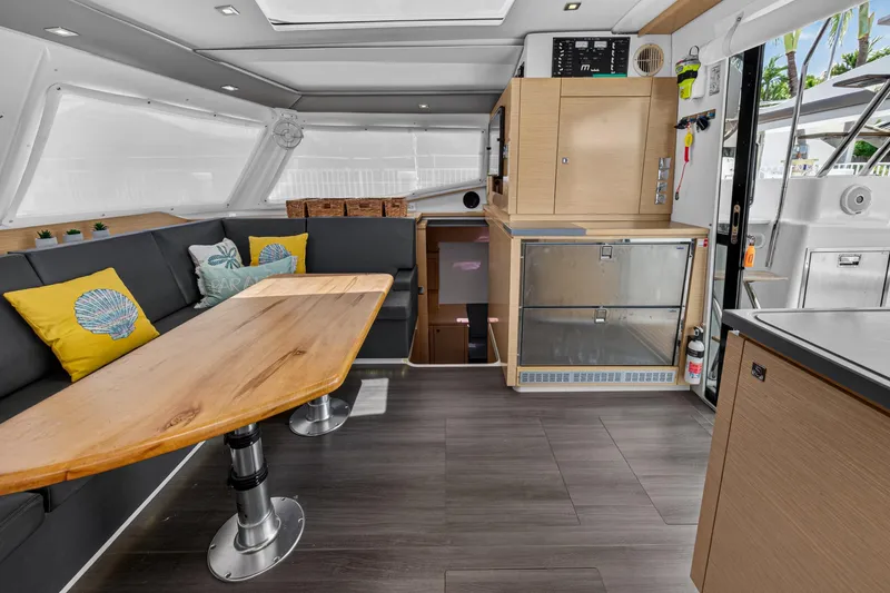 Slide: The Image of Interior of 2015 Fountaine Pajot Helia 44 catamaran with modern seating and wooden table. - 57