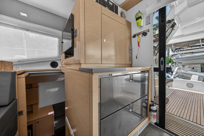 Slide: The Image of Interior of 2015 Fountaine Pajot Helia 44 catamaran with modern cabinetry and outdoor view. - 61