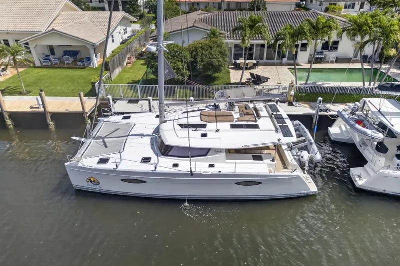 Slide: The Image of 2015 Fountaine Pajot Helia 44 catamaran docked near waterfront homes. - 7