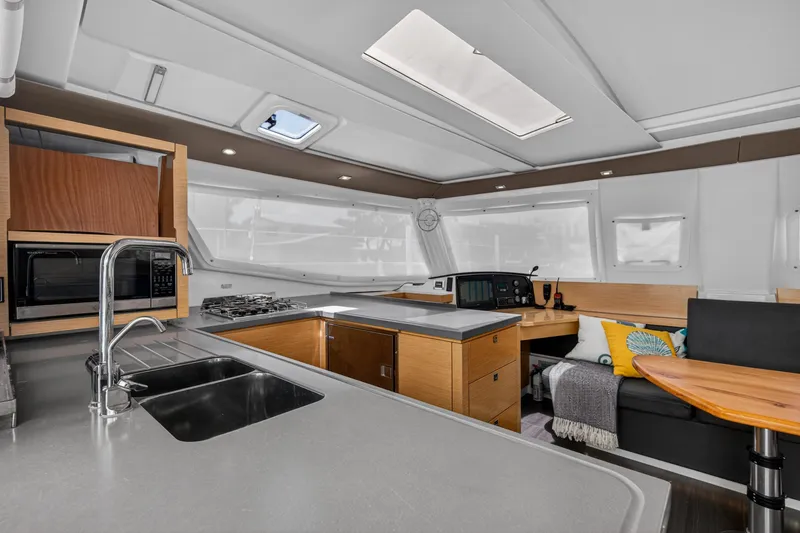 Slide: The Image of Interior of 2015 Fountaine Pajot Helia 44 catamaran with modern kitchen and seating area. - 70