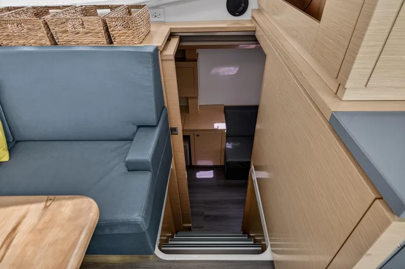 Slide: The Image of Interior of 2015 Fountaine Pajot Helia 44 yacht, featuring modern seating and wooden cabinetry. - 73