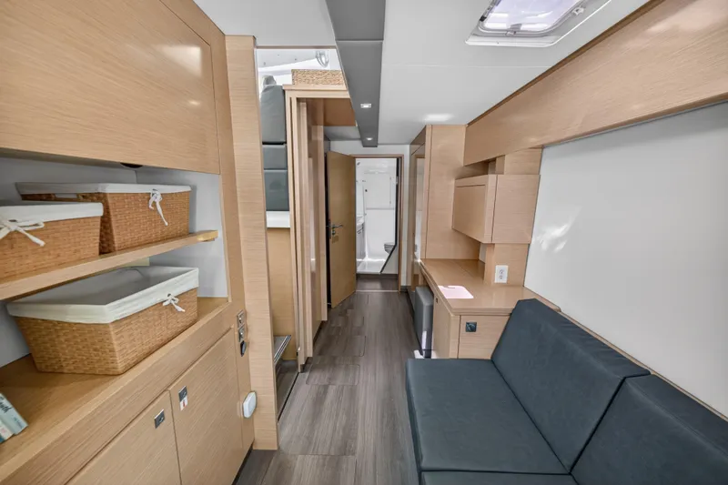Slide: The Image of Interior of 2015 Fountaine Pajot Helia 44 catamaran, featuring modern wood finishes and storage baskets. - 76