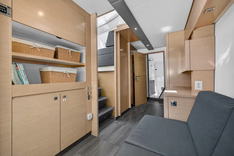 Slide: The Image of Interior of 2015 Fountaine Pajot Helia 44 catamaran with modern wood finish and storage baskets. - 77