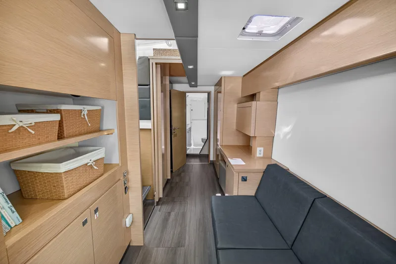 Slide: The Image of Interior of 2015 Fountaine Pajot Helia 44 catamaran, featuring modern wood finishes and cozy seating. - 79