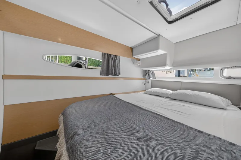 Slide: The Image of Interior cabin of 2015 Fountaine Pajot Helia 44 catamaran, featuring a cozy bed and modern design. - 85