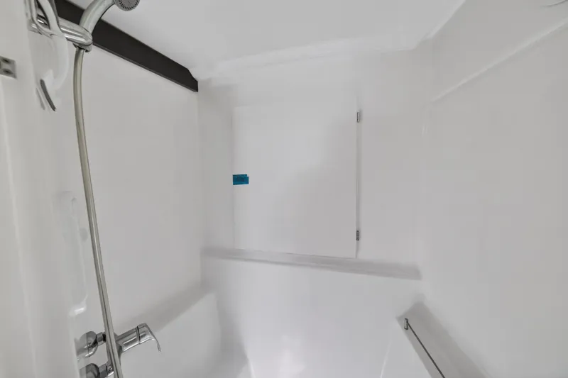 Slide: The Image of Shower area inside 2015 Fountaine Pajot Helia 44 catamaran, featuring sleek white design. - 89