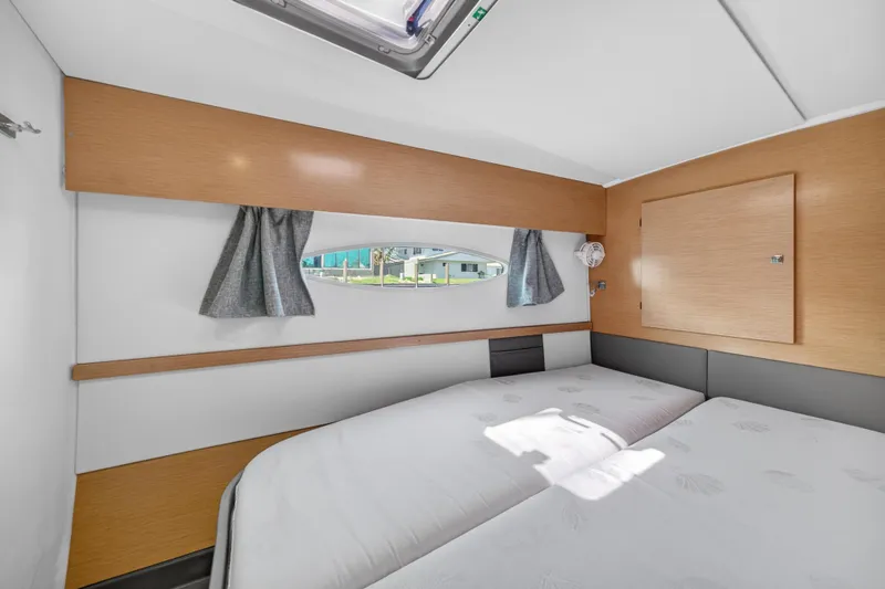 Slide: The Image of Cabin interior of 2015 Fountaine Pajot Helia 44 catamaran, featuring a cozy bed and window. - 94