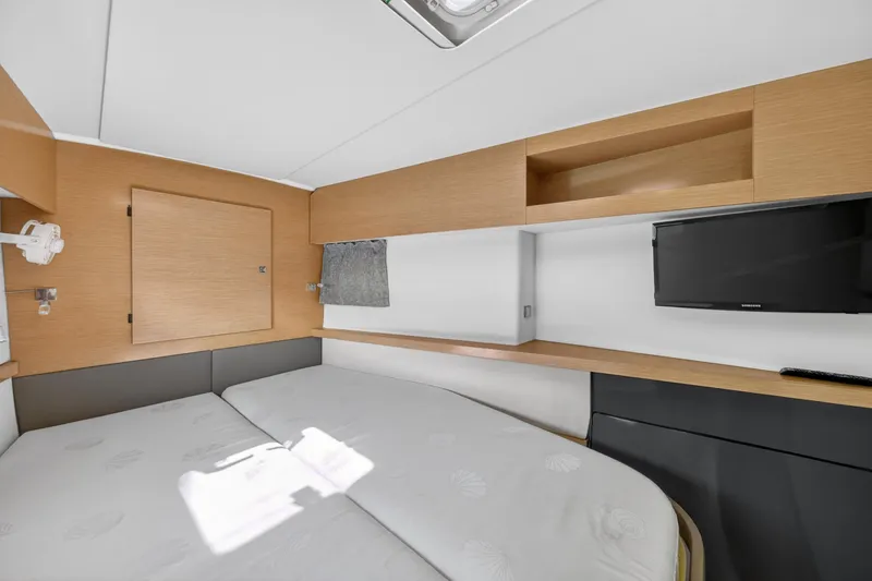 Slide: The Image of Interior cabin of 2015 Fountaine Pajot Helia 44 catamaran with bed, TV, and storage. - 95