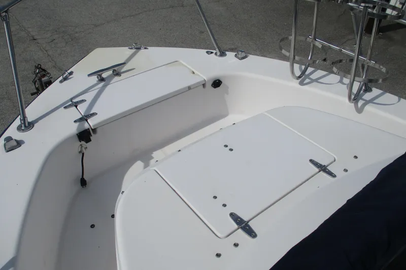 Slide: The Image of 1995 Grady-White Adventure 208 boat deck with storage compartments and railing. - 10