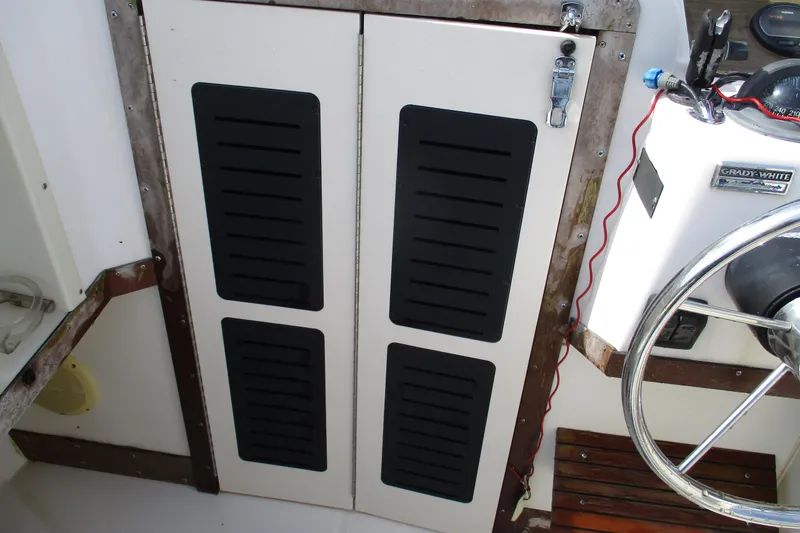 Slide: The Image of 1995 Grady-White Adventure 208 boat interior with steering wheel and storage compartments. - 14