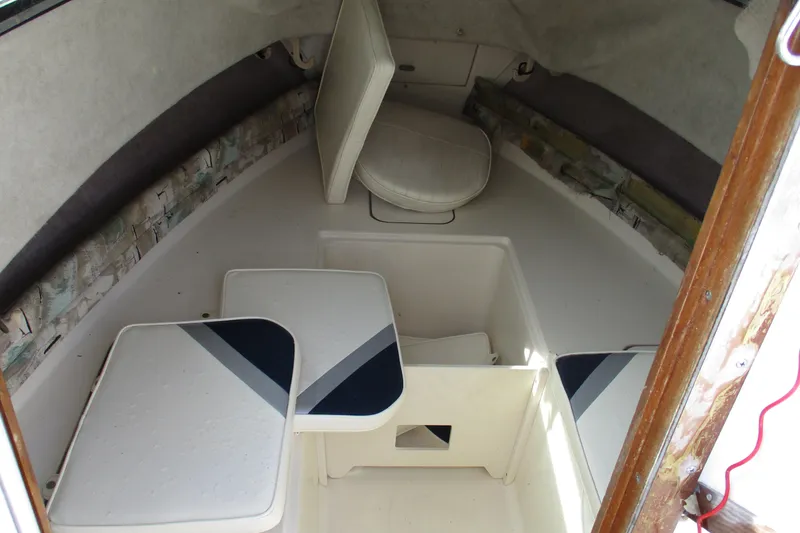 Slide: The Image of 1995 Grady-White Adventure 208 cabin interior with seating and storage compartments. - 15