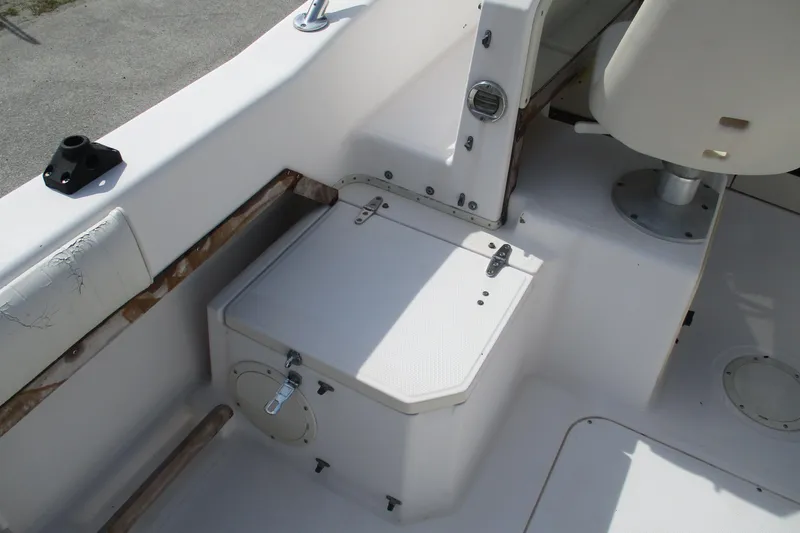 Slide: The Image of 1995 Grady-White Adventure 208 boat interior with seating and storage compartment. - 16