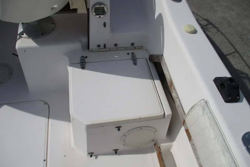 Slide: The Image of 1995 Grady-White Adventure 208 boat interior, featuring a white storage compartment and seating area. - 19