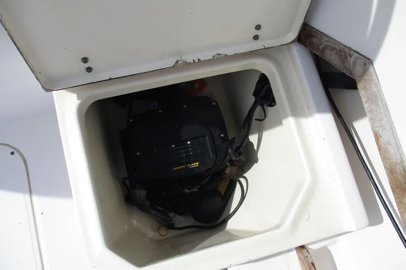 Slide: The Image of Storage compartment of a 1995 Grady-White Adventure 208 boat, featuring marine equipment. - 21