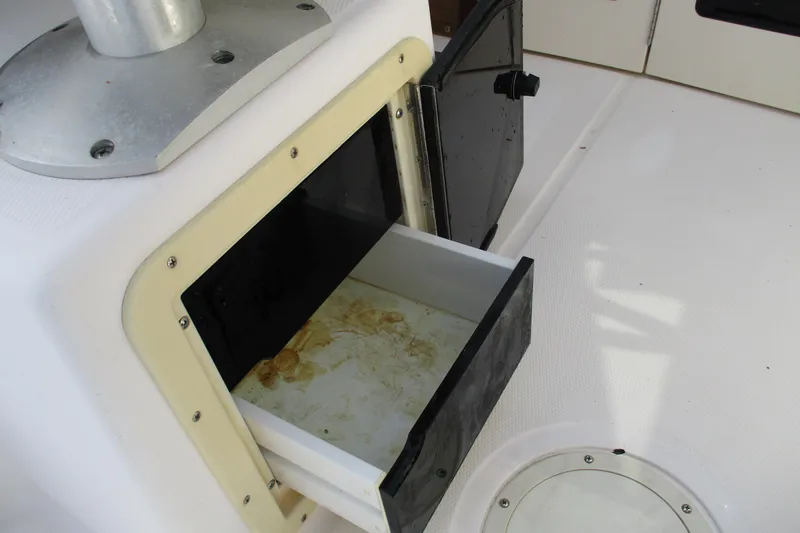 Slide: The Image of Open storage compartment on 1995 Grady-White Adventure 208 boat deck. - 23