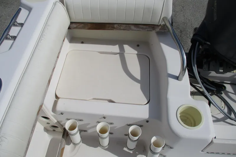 Slide: The Image of 1995 Grady-White Adventure 208 boat interior with rod holders and seating area. - 29