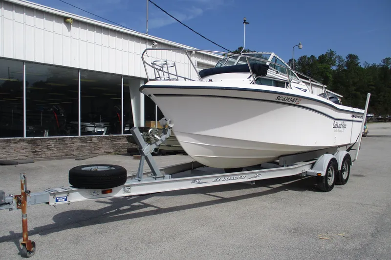 Slide: The Image of 1995 Grady-White Adventure 208 boat on trailer outside a showroom. - 3