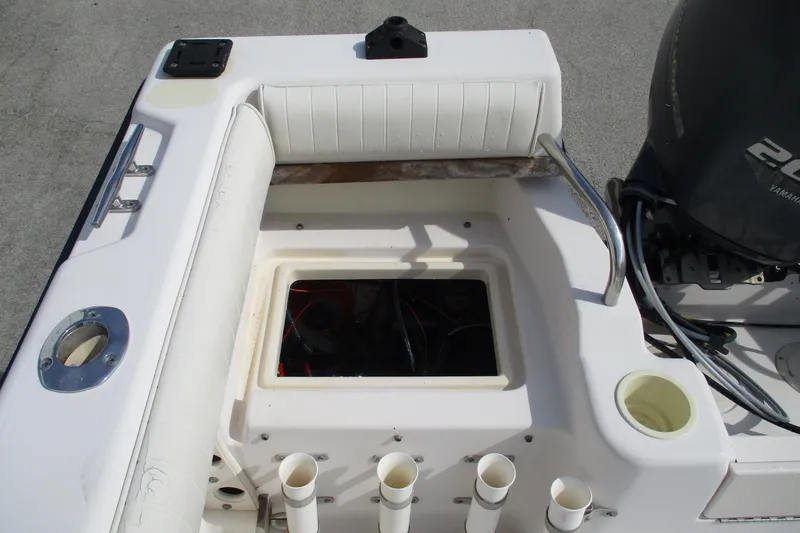 Slide: The Image of 1995 Grady-White Adventure 208 boat interior with storage compartment and Yamaha engine. - 30