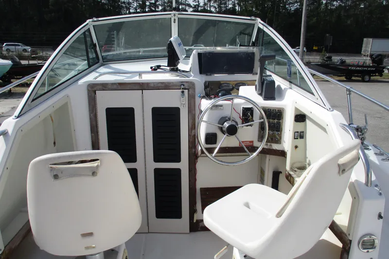Slide: The Image of 1995 Grady-White Adventure 208 boat cockpit with steering wheel and seating. - 32