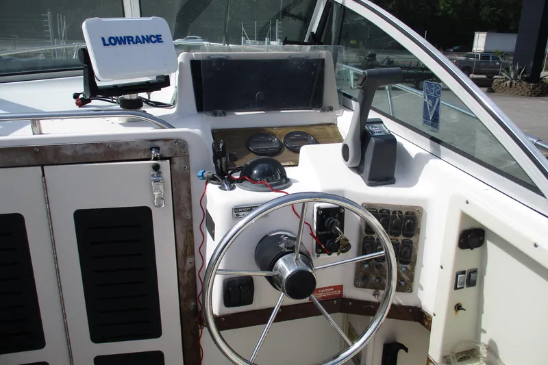 Slide: The Image of 1995 Grady-White Adventure 208 boat dashboard with steering wheel and navigation equipment. - 33