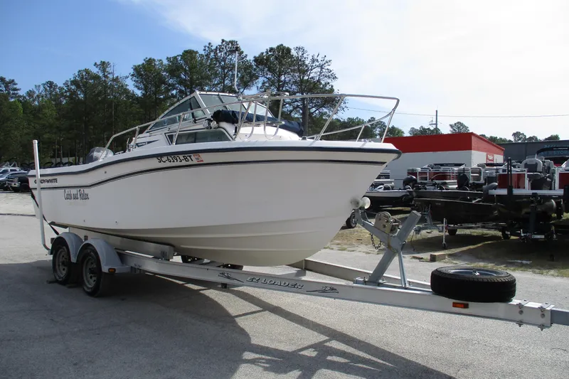 Slide: The Image of 1995 Grady-White Adventure 208 boat on trailer in outdoor setting. - 5