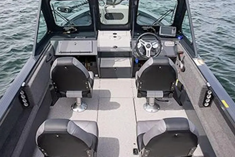 Slide: The Image of 2026 Crestliner 1850 Commander boat interior with four seats and steering wheel on water. - 4