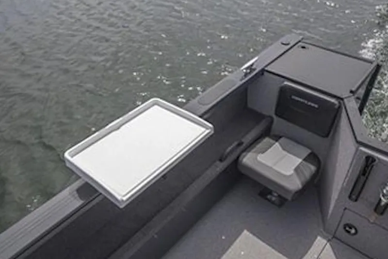 Slide: The Image of 2026 Crestliner 1850 Commander boat interior with seating and water view. - 7