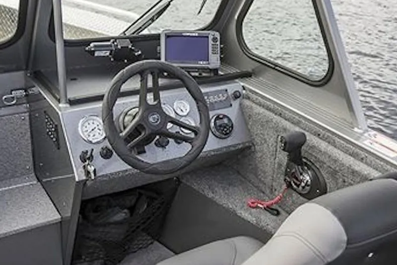 Slide: The Image of Interior of 2026 Crestliner 1850 Commander boat, featuring steering wheel and control panel. - 8