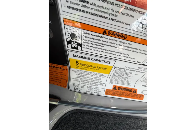 Slide: The Image of 2025 Skeeter ZXR21 capacity label, warning signs, and safety instructions. - 16