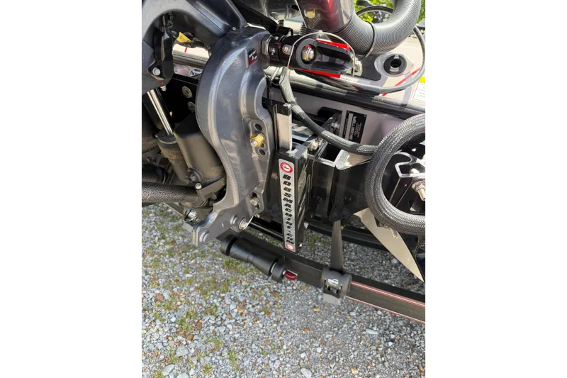 Slide: The Image of Close-up of 2025 Skeeter ZXR21 boat engine components on gravel surface. - 17