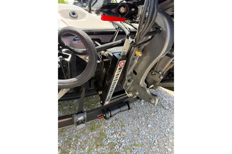 Slide: The Image of Close-up of 2025 Skeeter ZXR21 boat engine components on gravel surface. - 18