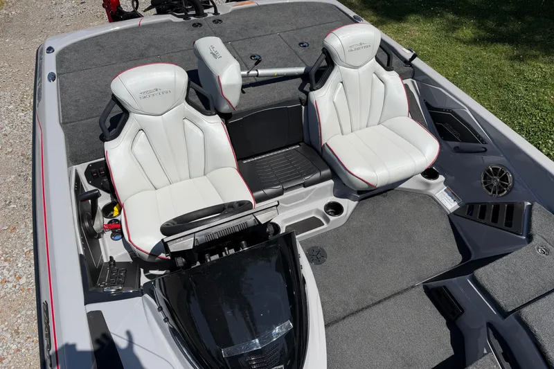 Slide: The Image of 2025 Skeeter ZXR21 boat interior with dual white seats and modern dashboard. - 6