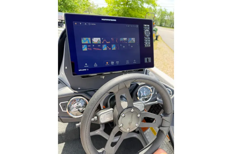 Slide: The Image of Steering wheel and dashboard of 2025 Skeeter ZXR21 boat with advanced navigation display. - 7