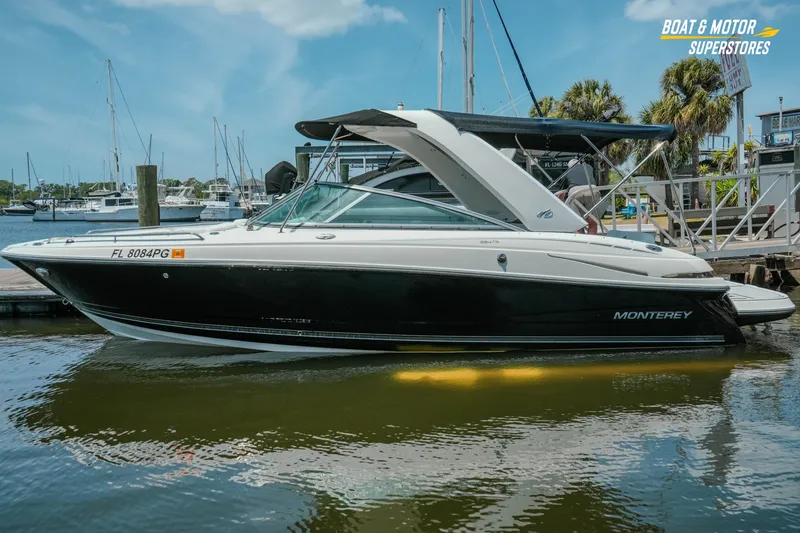 The Image of 2012 Monterey 264FS boat docked at marina under clear blue sky. - 0