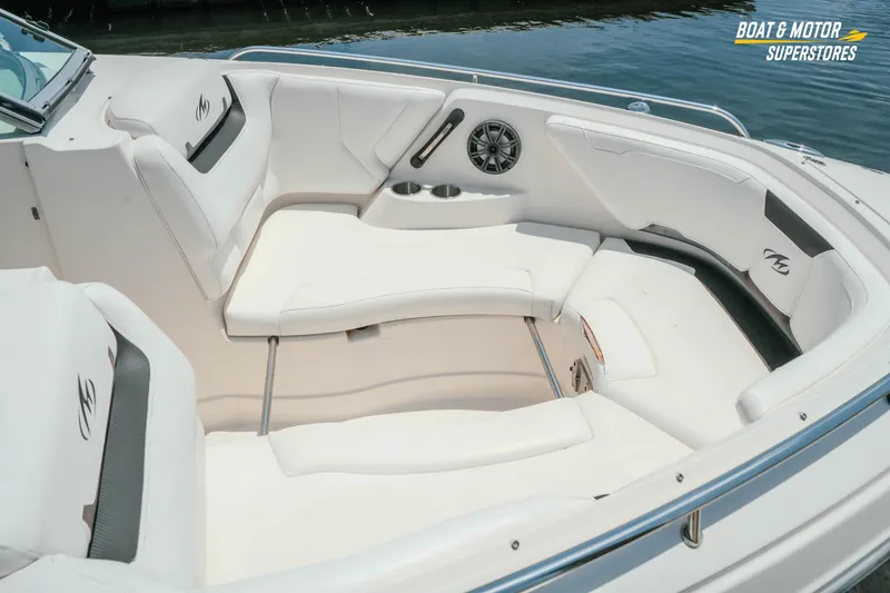 Slide: The Image of Luxurious seating area on a 2012 Monterey 264FS boat, featuring white upholstery and cup holders. - 15