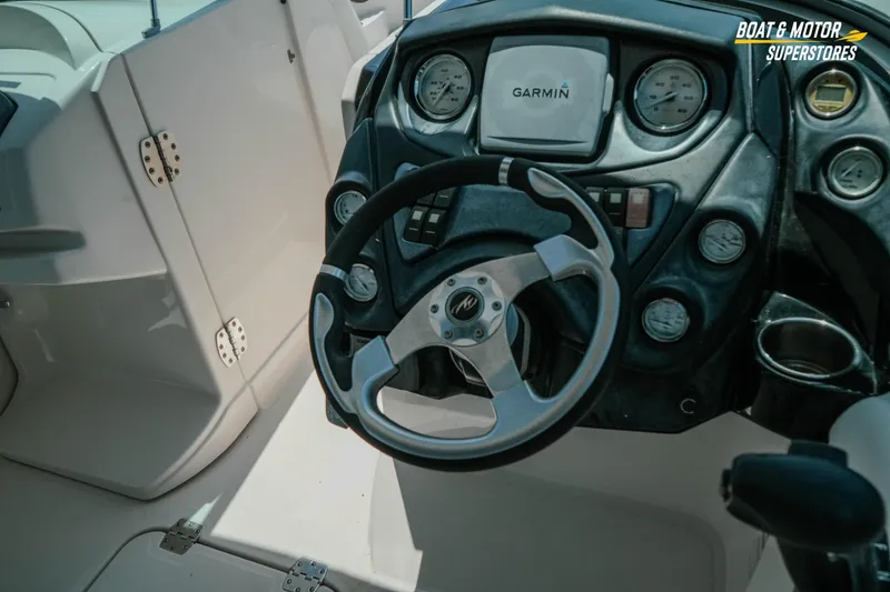 Slide: The Image of Steering wheel and dashboard of 2012 Monterey 264FS boat with Garmin system. - 17