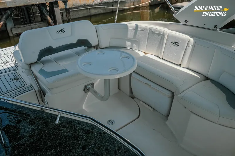 Slide: The Image of Interior seating area of a 2012 Monterey 264FS boat with a round table. - 18