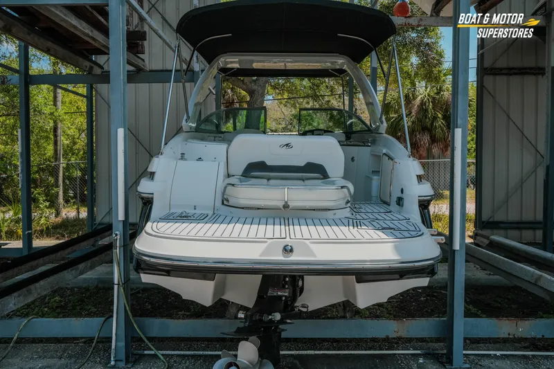 Slide: The Image of 2012 Monterey 264FS boat in storage, rear view with swim platform and seating. - 2