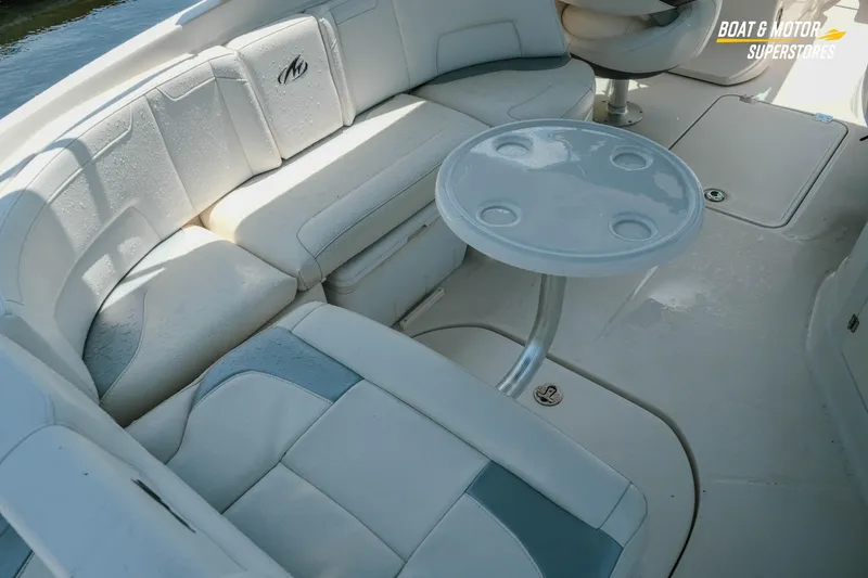 Slide: The Image of Interior seating of a 2012 Monterey 264FS boat with a small table. - 22