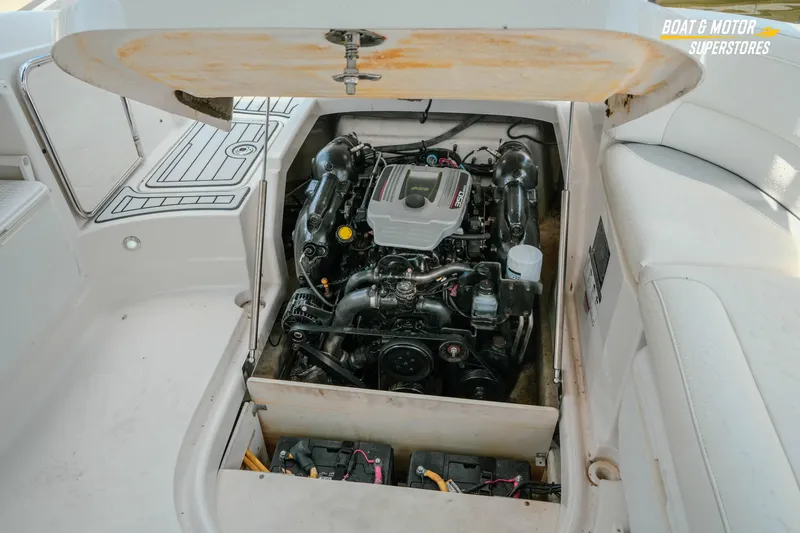 Slide: The Image of 2012 Monterey 264FS boat engine compartment with open hatch, showcasing engine details. - 23