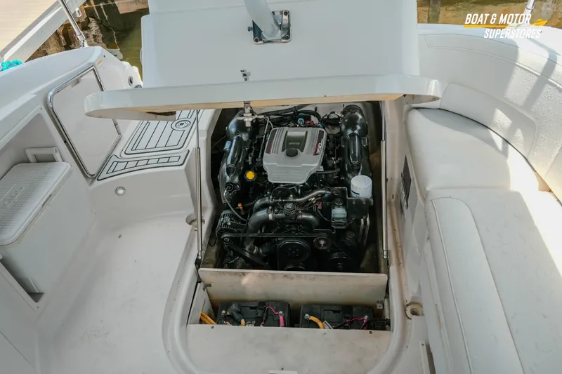 Slide: The Image of Open engine compartment of a 2012 Monterey 264FS boat, showcasing the engine details. - 26