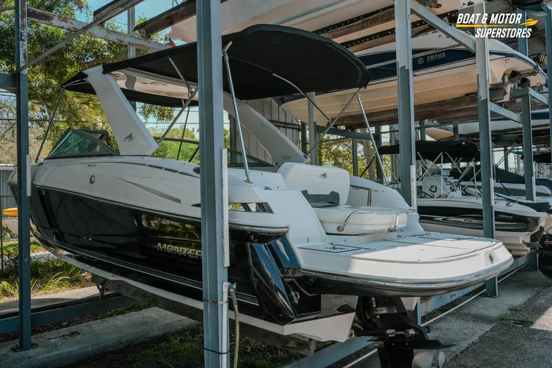 Slide: The Image of 2012 Monterey 264FS boat in storage, featuring sleek design and black-and-white color scheme. - 3