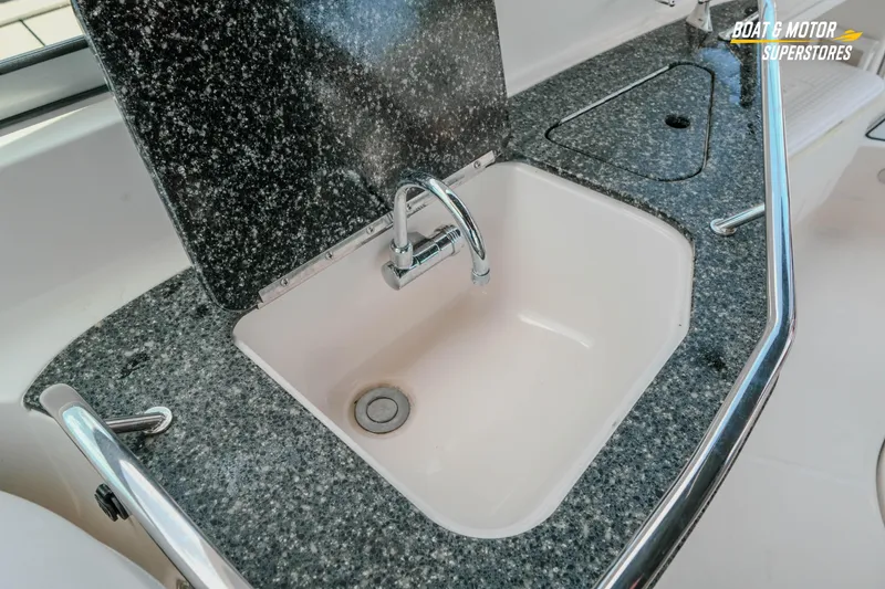 Slide: The Image of 2012 Monterey 264FS boat sink with granite countertop and chrome faucet. - 31