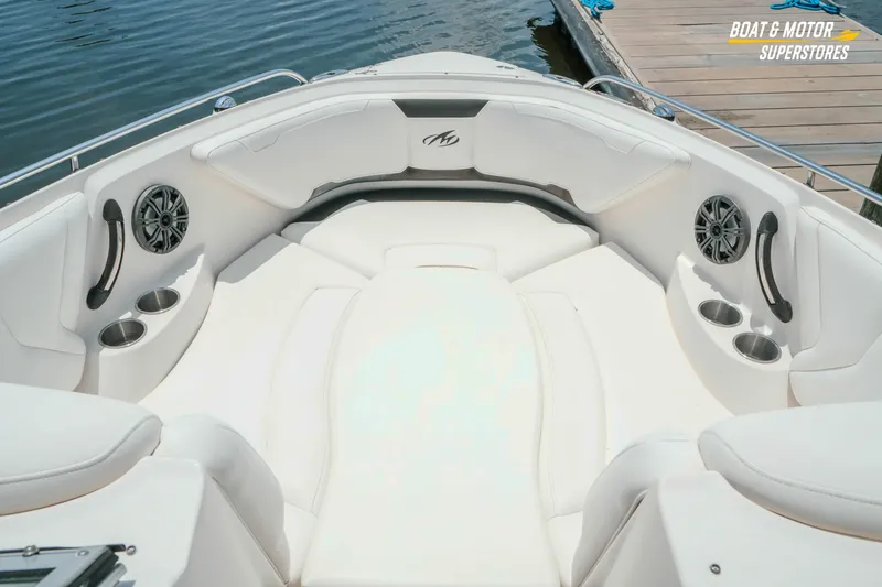 Slide: The Image of 2012 Monterey 264FS boat interior with white seating and cup holders. - 35