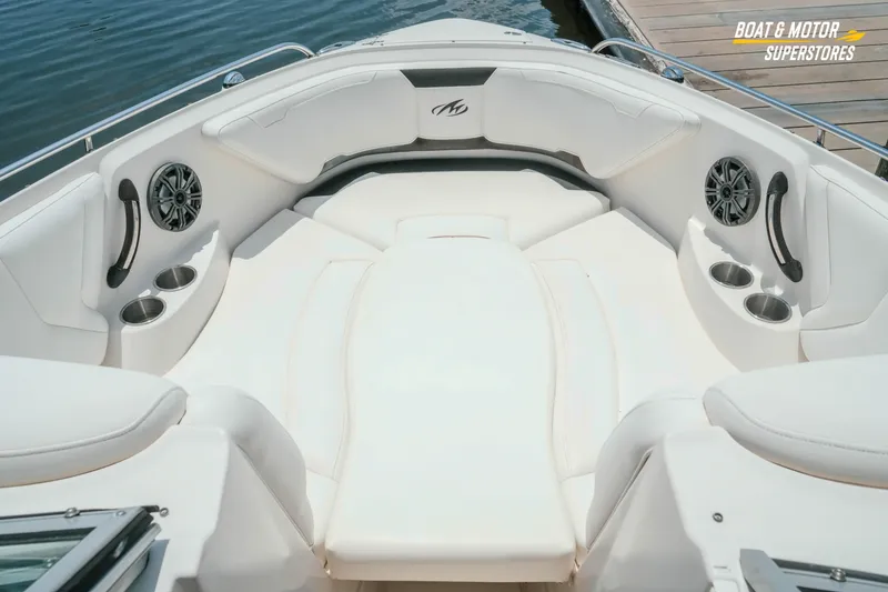Slide: The Image of 2012 Monterey 264FS boat interior with white seating, cup holders, and speakers. - 36